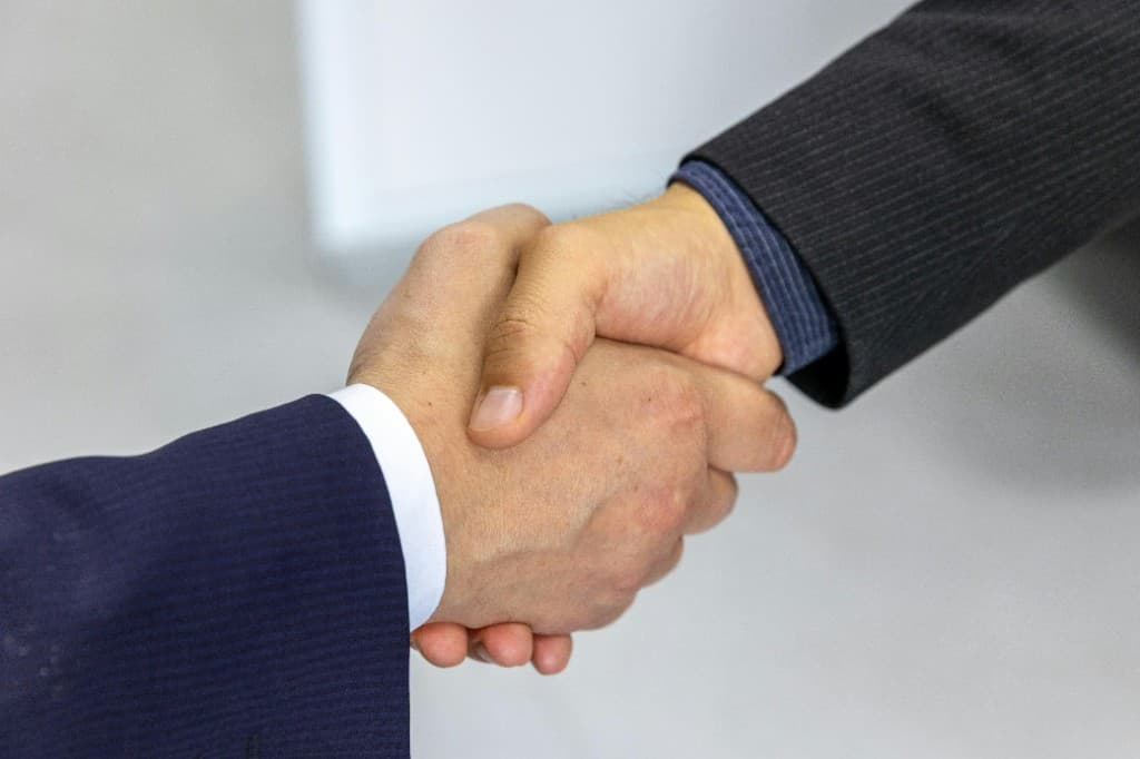 Deux professionnels se serrant la main, symbole de confiance et d’accord